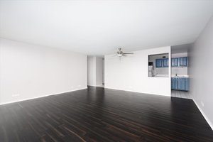 4343 North Clarendon Avenue, Unit 1113 Chicago, IL 60613 - Photo 3 of 7 a view of a big room with wooden floor and a kitchen