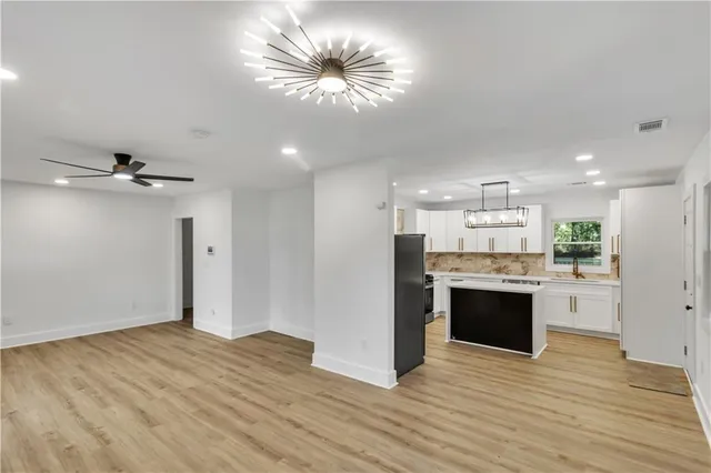 a view of a kitchen with a sink and refrigerator
