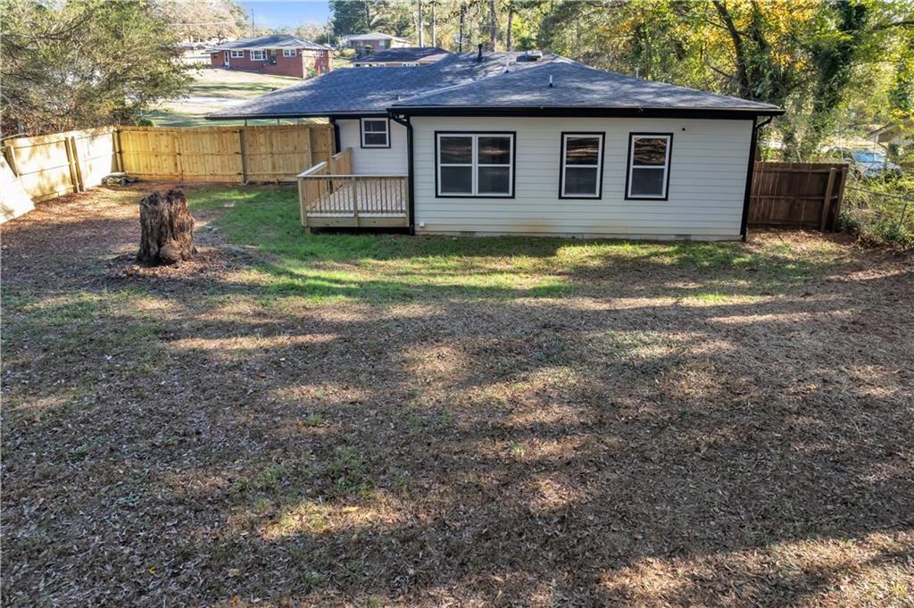 2358 Tilson Road Decatur, GA 30032 - Photo 13 of 14 a view of a house with a yard and lawn chairs under an umbrella