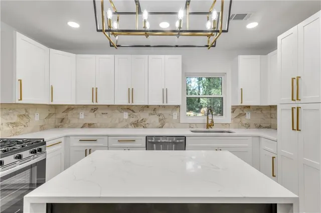 a kitchen with a stove a sink and cabinets