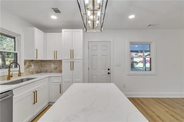 a spacious bathroom with a sink a large mirror and a shower