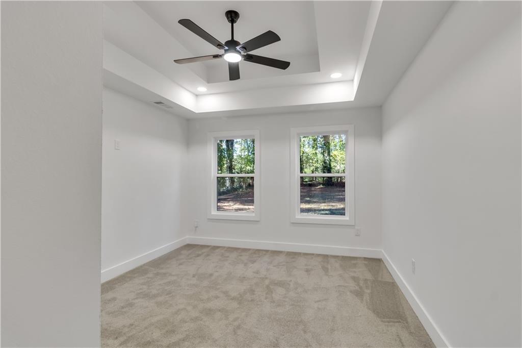2358 Tilson Road Decatur, GA 30032 - Photo 7 of 14 an empty room with a ceiling fan and windows