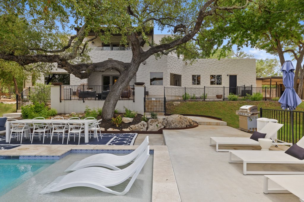 716 North Commons Ford Road Austin, TX 78733 - Photo 23 of 30 Expansive outdoor living area featuring a concrete patio, integrated swimming pool, and a dedicated dining space