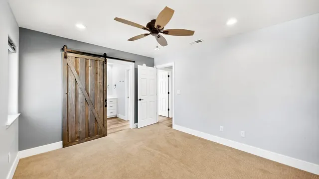 a view of a livingroom with a ceiling fan and window