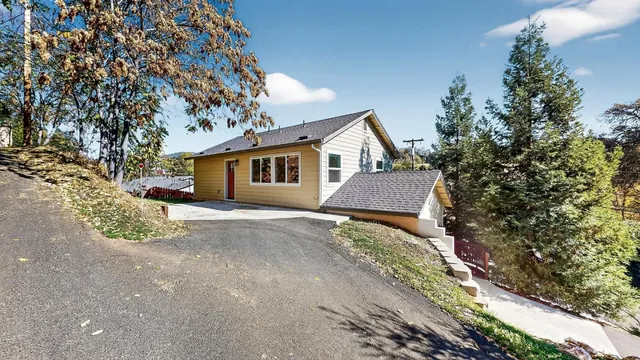 a view of a house with a yard and garage
