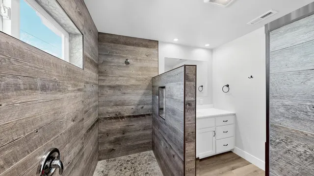 a bathroom with a shower and a mirror