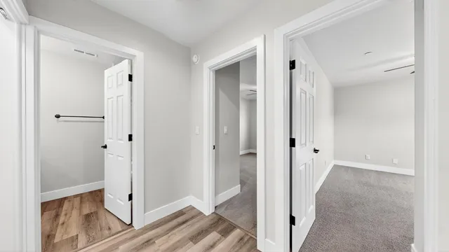 an empty room with a window and a fan