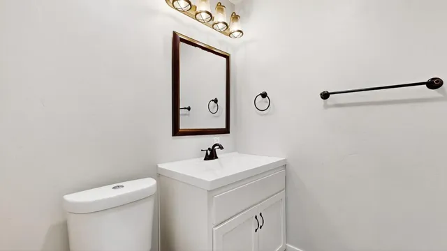 a bathroom with a tub a sink and wooden floor
