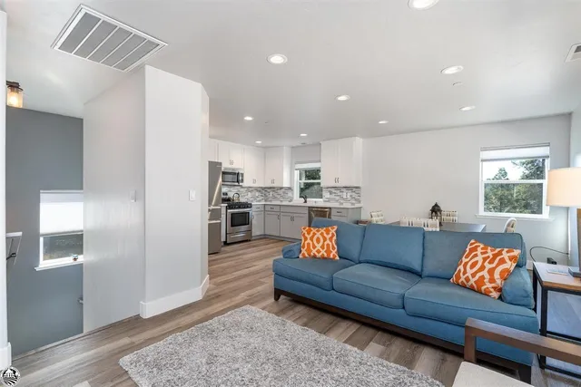 a living room with a flat screen tv and a fireplace
