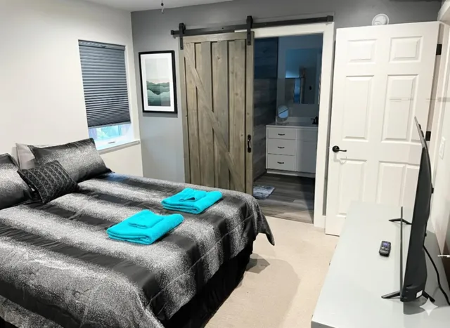 a bedroom with a large bed and a window