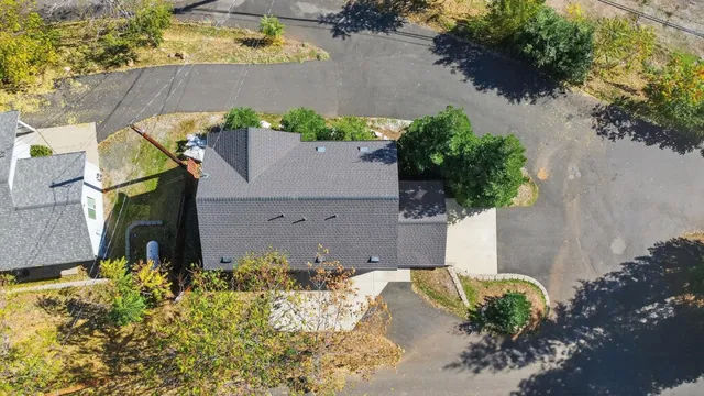an aerial view of a house with a yard and lake view