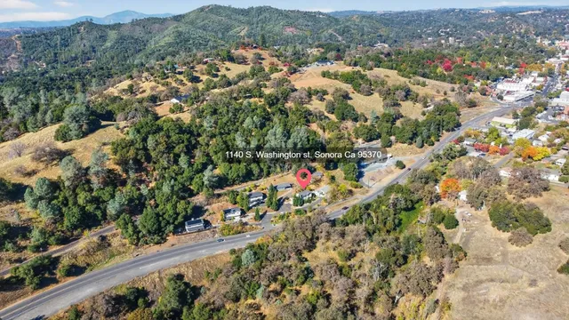 a view of a house with a yard and garage