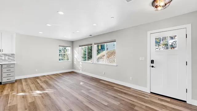 wooden floor in an empty room with a window