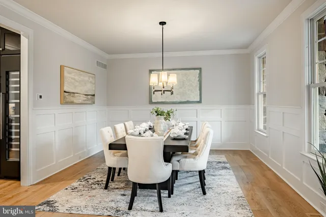 a kitchen with kitchen island granite countertop a sink a stove a dining table and chairs