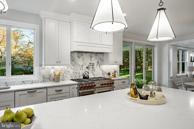 a view of a staircase with wooden floor and white walls