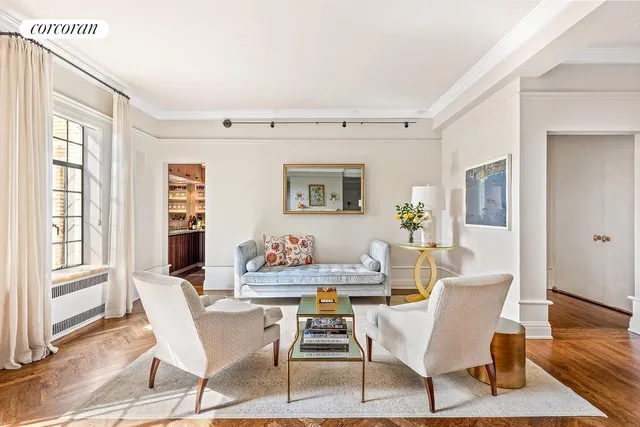 a dining room with wooden floor and large windows