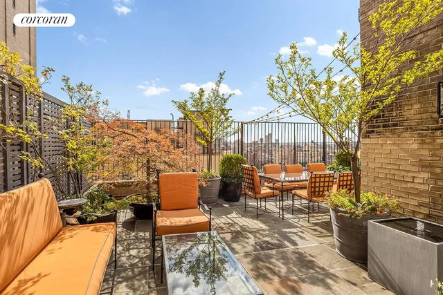 an outdoor sitting area with couch and outdoor seating