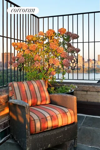 a balcony with furniture and a potted plant