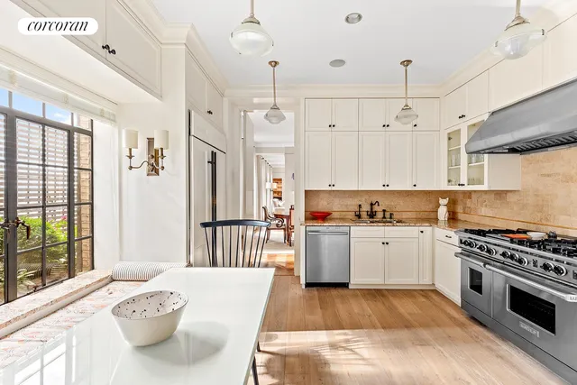 a dining room with furniture a chandelier and wooden floor