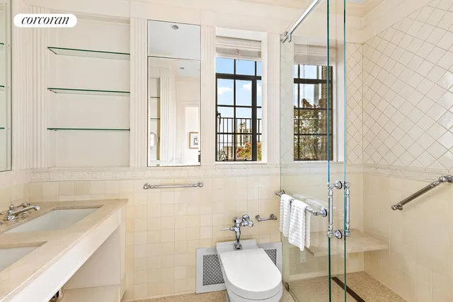 a bedroom with a large bed and a flat tv screen on dresser