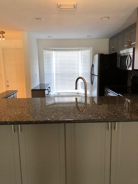 1072 Jeffery Street Boca Raton, FL 33487 - Photo 11 of 38 a kitchen with granite countertop a sink and cabinets