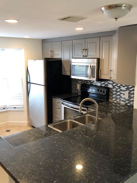 1072 Jeffery Street Boca Raton, FL 33487 - Photo 18 of 38 a kitchen with a refrigerator sink and stove
