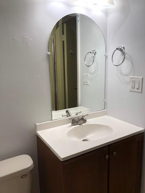 1072 Jeffery Street Boca Raton, FL 33487 - Photo 32 of 38 a bathroom with a sink vanity and toilet