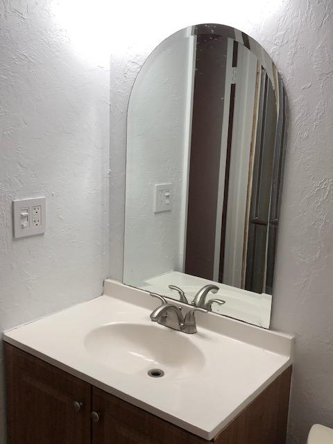 1072 Jeffery Street Boca Raton, FL 33487 - Photo 34 of 38 a bathroom with a sink and a mirror