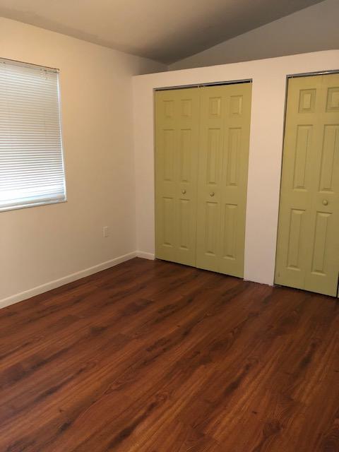 1072 Jeffery Street Boca Raton, FL 33487 - Photo 37 of 38 a view of an empty room with wooden floor and a window