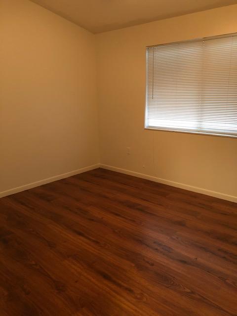 1072 Jeffery Street Boca Raton, FL 33487 - Photo 38 of 38 an empty room with wooden floor and windows
