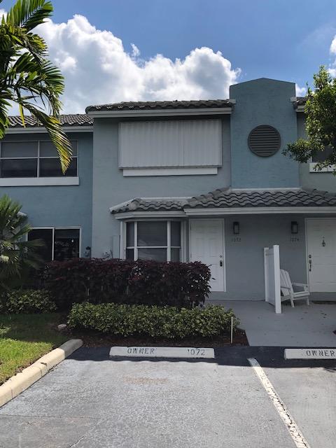 1072 Jeffery Street Boca Raton, FL 33487 - Photo 7 of 38 a front view of a house with garden