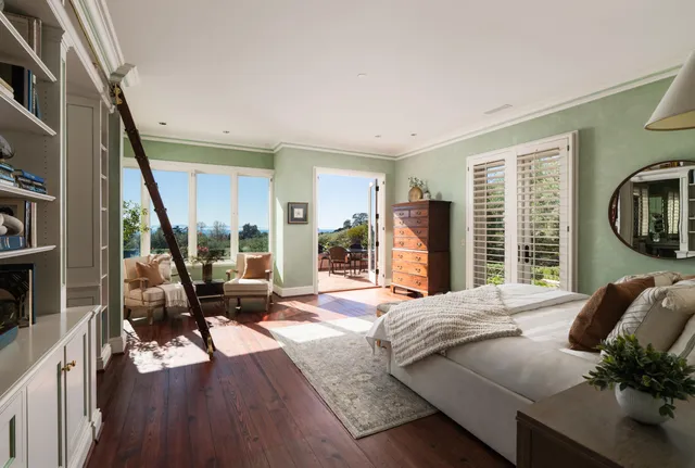 a living room with furniture and a floor to ceiling window