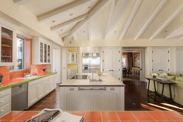 a large white kitchen with a large window