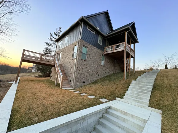 a view of a house with a wooden fence