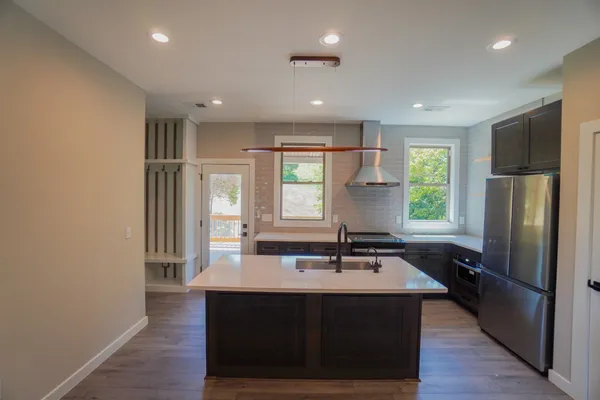 a kitchen with a sink appliances and cabinets