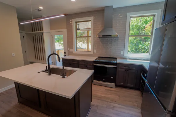 a kitchen with a sink appliances and cabinets