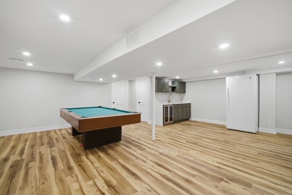 50 Glenview Road Glenview, IL 60025 - Photo 14 of 20 an empty room with wooden floor and kitchen view