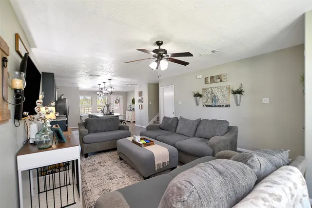 a living room with furniture fireplace and a chandelier