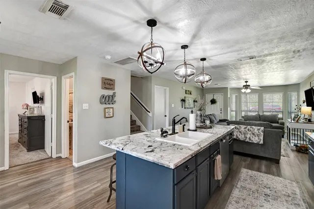 a kitchen with a table chairs and chandelier