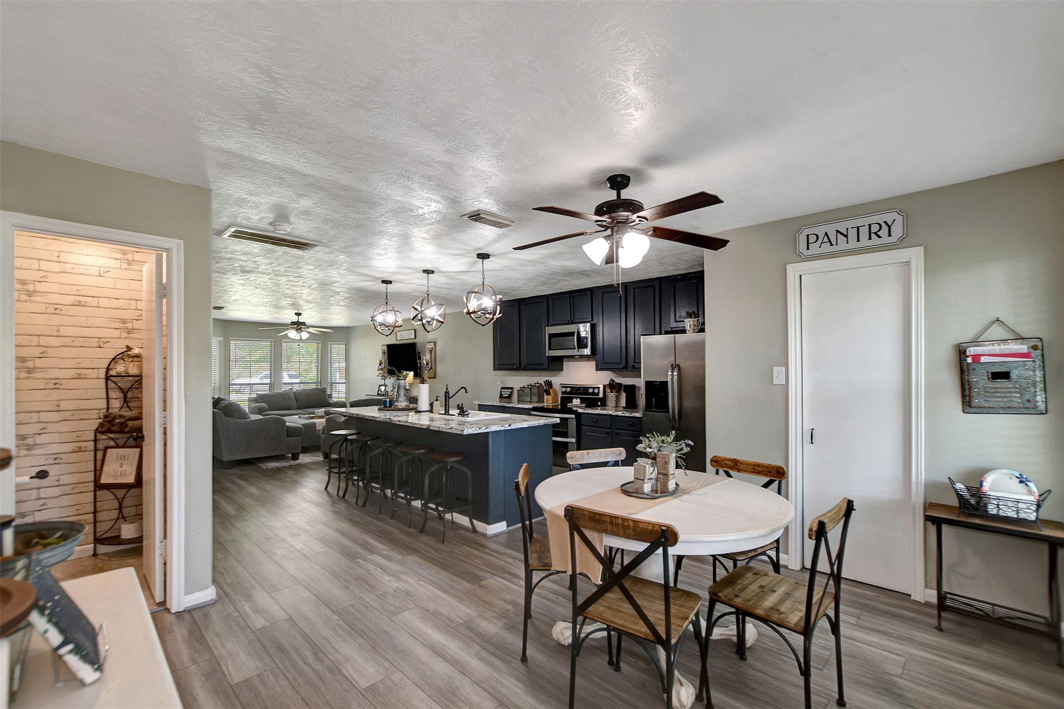 25401 Hunting Trail Magnolia, TX 77355 - Photo 18 of 50 a view of a dining room with furniture and wooden floor