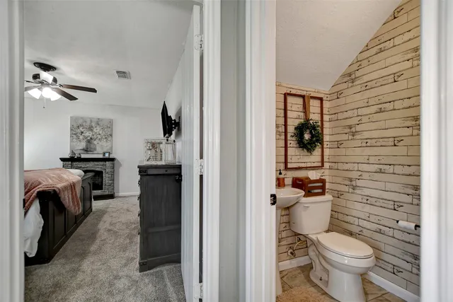 a bathroom with a toilet and a shower