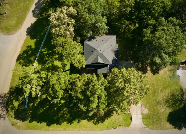 an aerial view of a house with a yard and outdoor seating