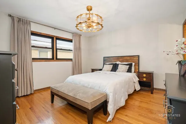 a bedroom with a bed and a chandelier