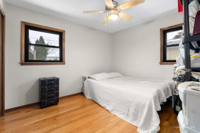a bedroom with a bed and a lamp on dresser