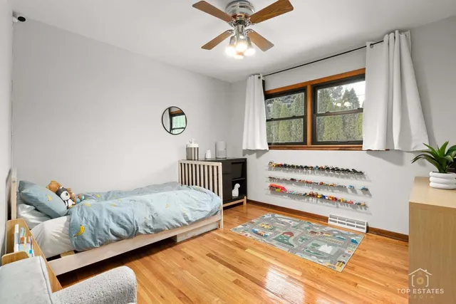 a bedroom with furniture and a large window