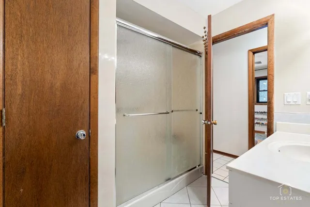a bathroom with a shower and a sink