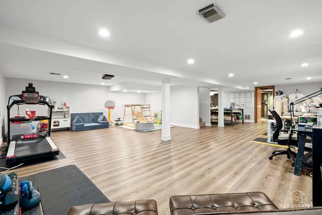 a room with lots of furniture and a wooden floor