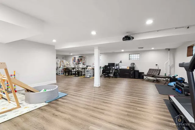 a view of a living room and kitchen with furniture wooden floor and windows