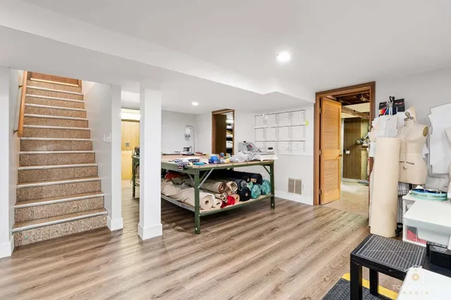 a bedroom with furniture and wooden floor