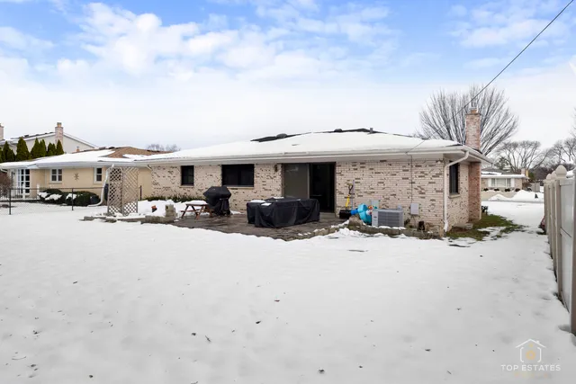 a view of a house with cars parked in front of house